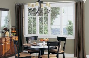 brown curtains on a large window near a dining table