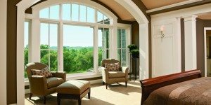 bedroom with foot of the bed facing a large window