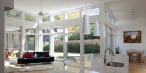 Interior view of modern home with many floor-to-ceiling windows.