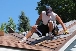 Worker repairing roof