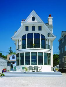 A multi-story home with many glass windows, including double-hung