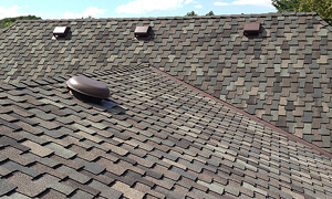 A close-up shot of a newly replaced roof with stylish shingles in neutral colros