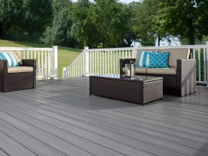 An outdoor deck with white railing and patio furniture