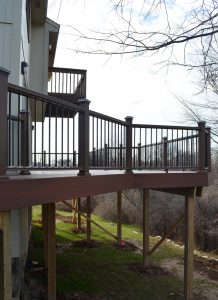A brown deck of a home about 6 feet off the ground
