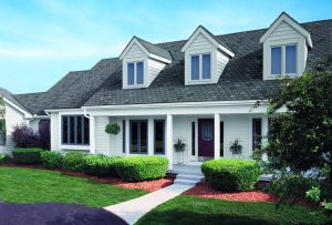 White suburban home with grey asphalt shingles