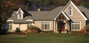 Large suburban home with asphalt shingle roofing