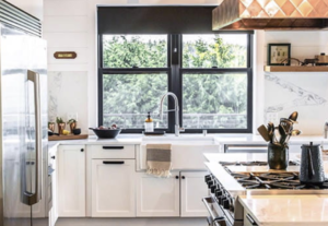 A sleek and beautiful set of large Andersen windows featured above a kitchen sink