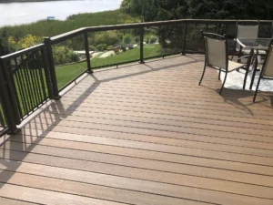 Deck ideas: composite deck with glass panels and metal railings - Deck builders in Michigan