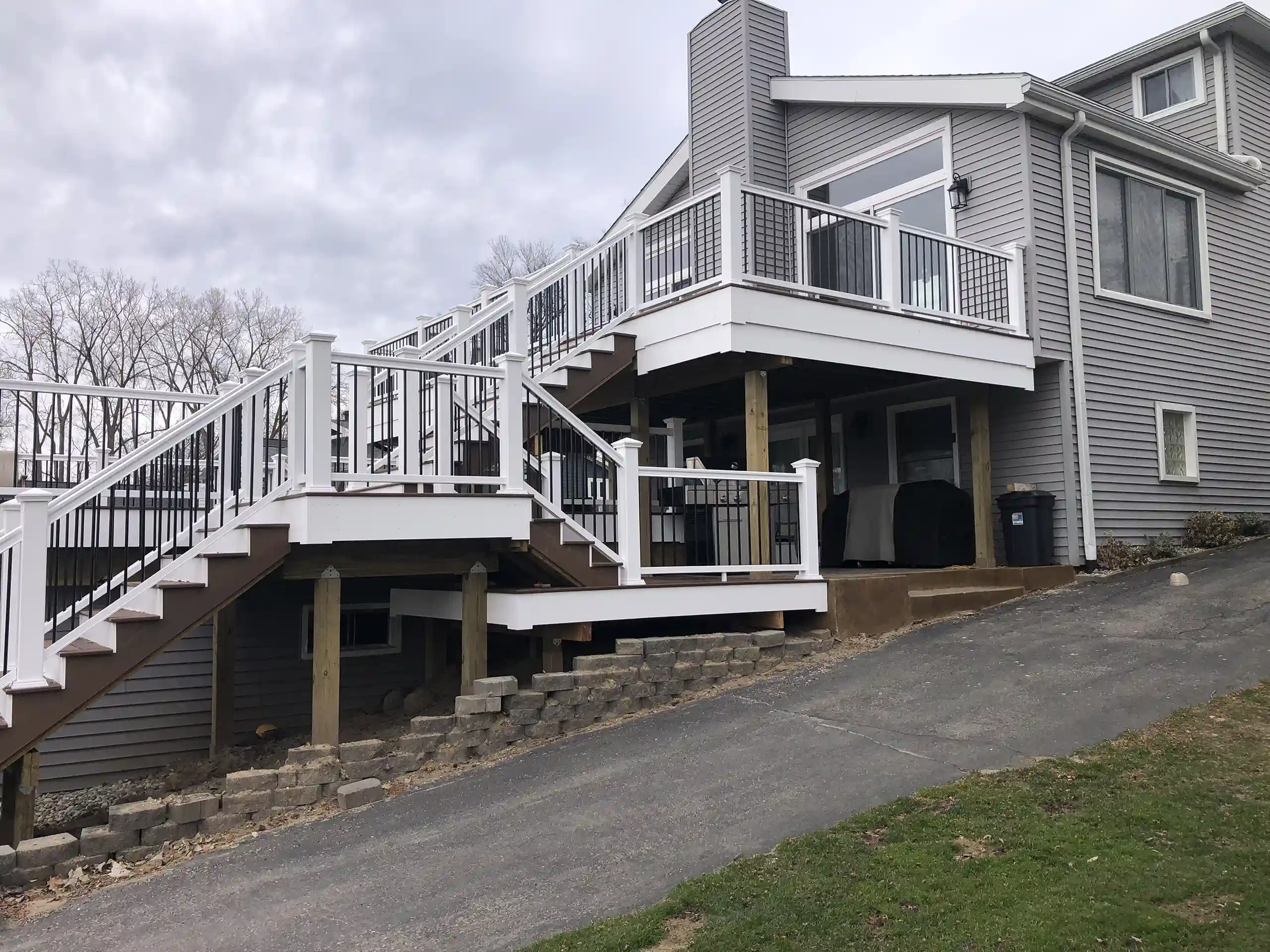 photo of a multi-level deck with steps and railing - Custom multi-level Deck builder and contractor in Michigan
