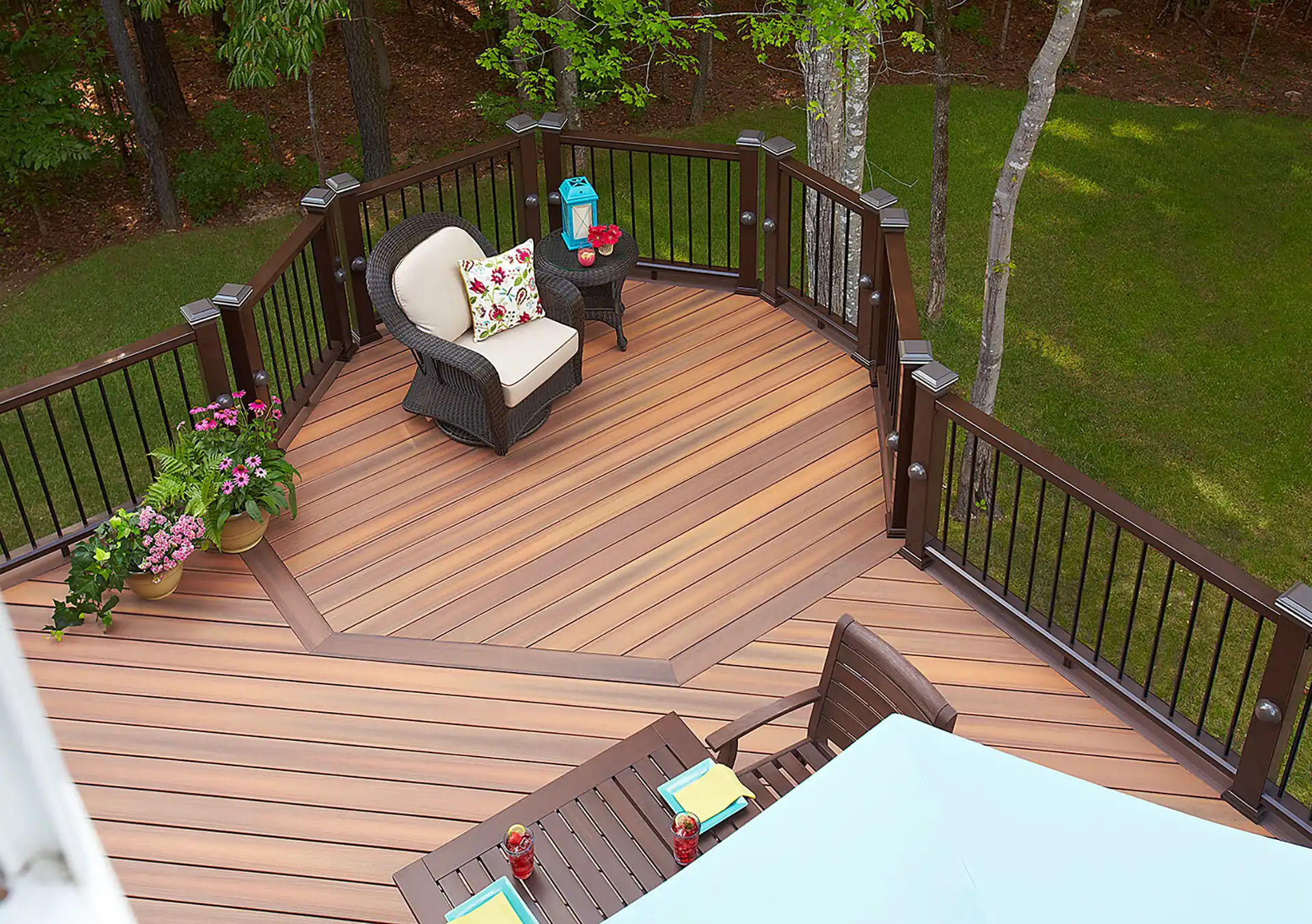 photo of an angled curved deck with outdoor furniture and deck railing - Curved Deck Builders Michigan