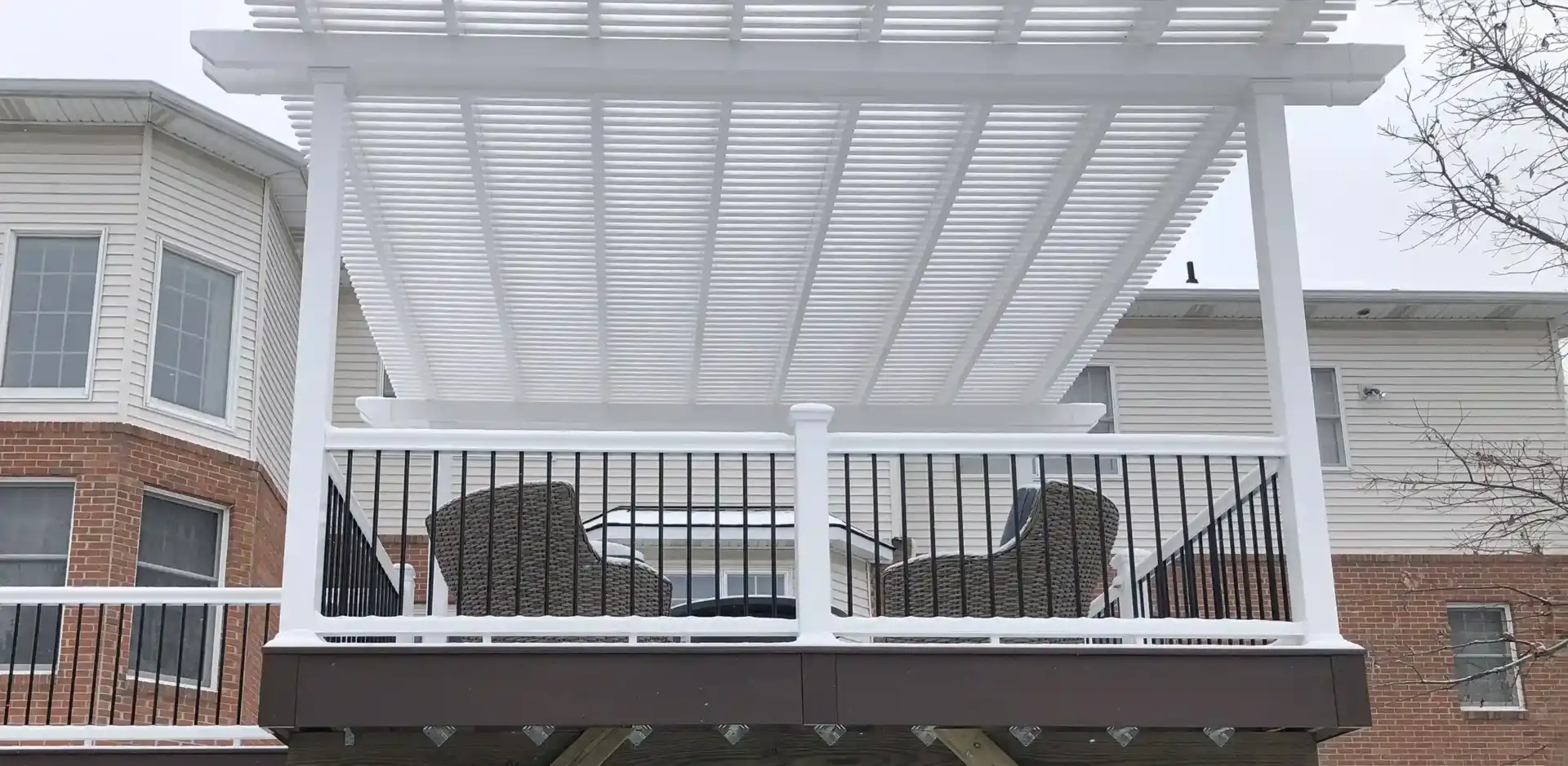 Pergola Design Ideas - Photo of a white pergola providing cover for an outdoor living room on an elevated deck - Pergola Builders in Michigan