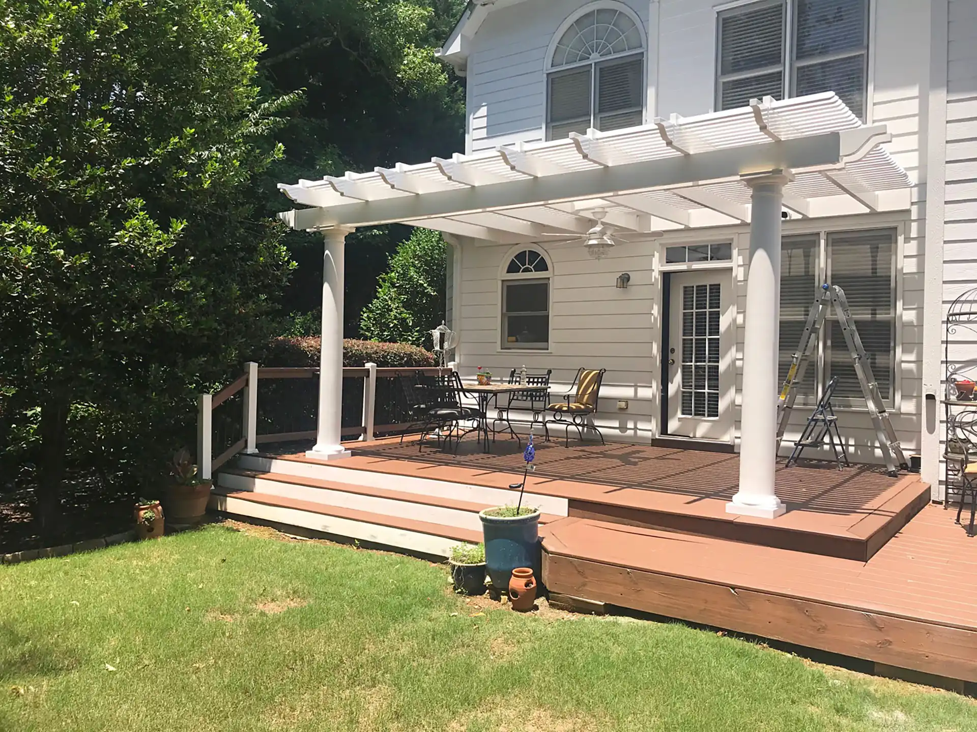 Pergola Design Ideas - photo of a classic pergola with round columns on a raised deck with outdoor furniture - Pergola Builders in Michigan